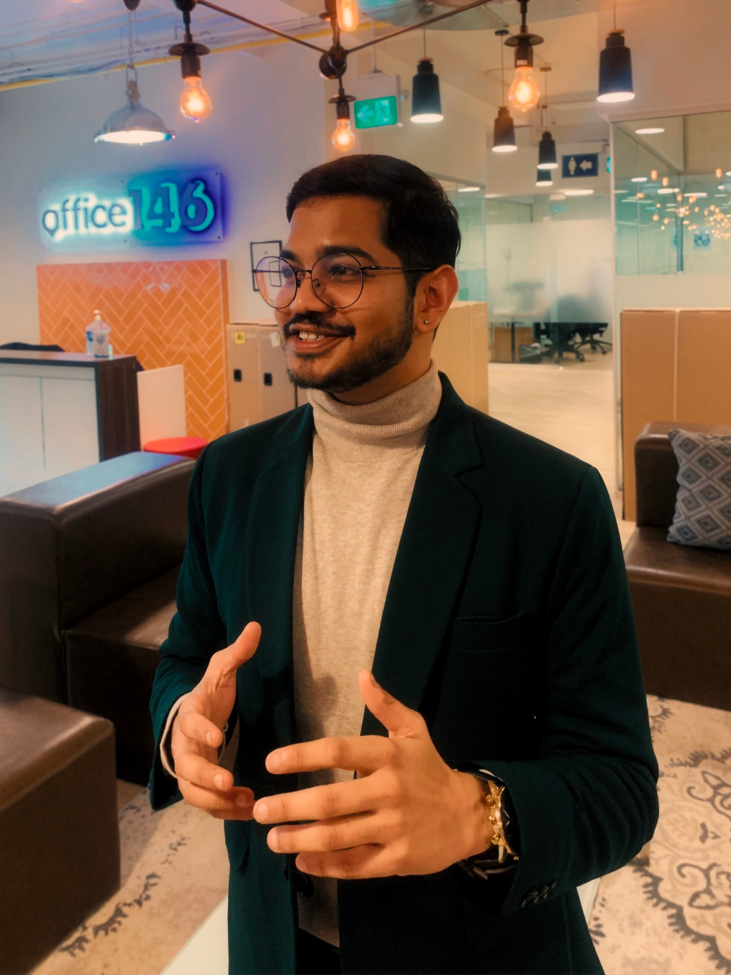 Satvik speaking in a blazer at an event